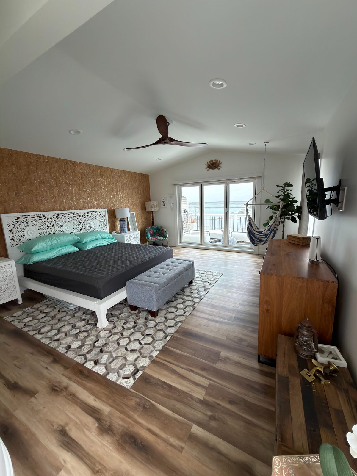 Freshly painted bedroom with light walls and wood flooring