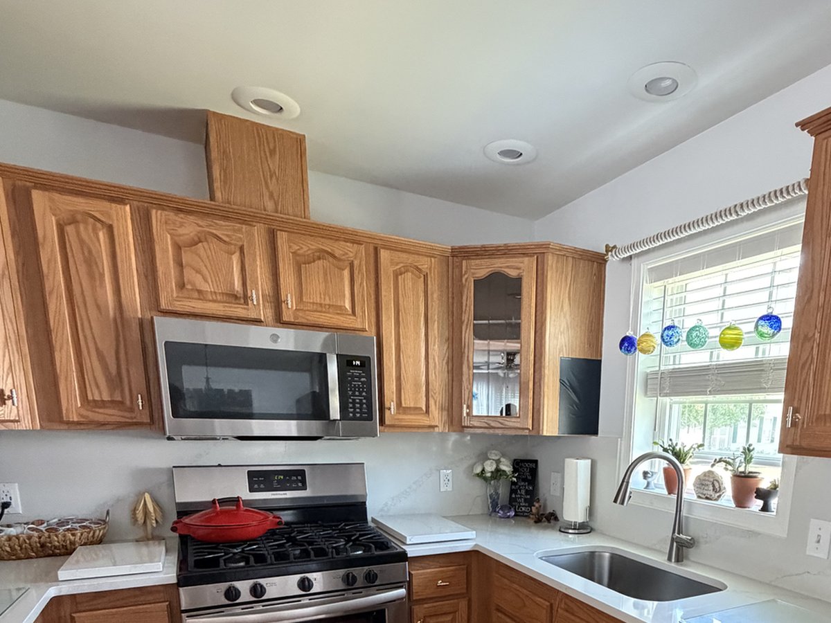 Kitchen before cabinet refinishing, with honey oak wood cabinets