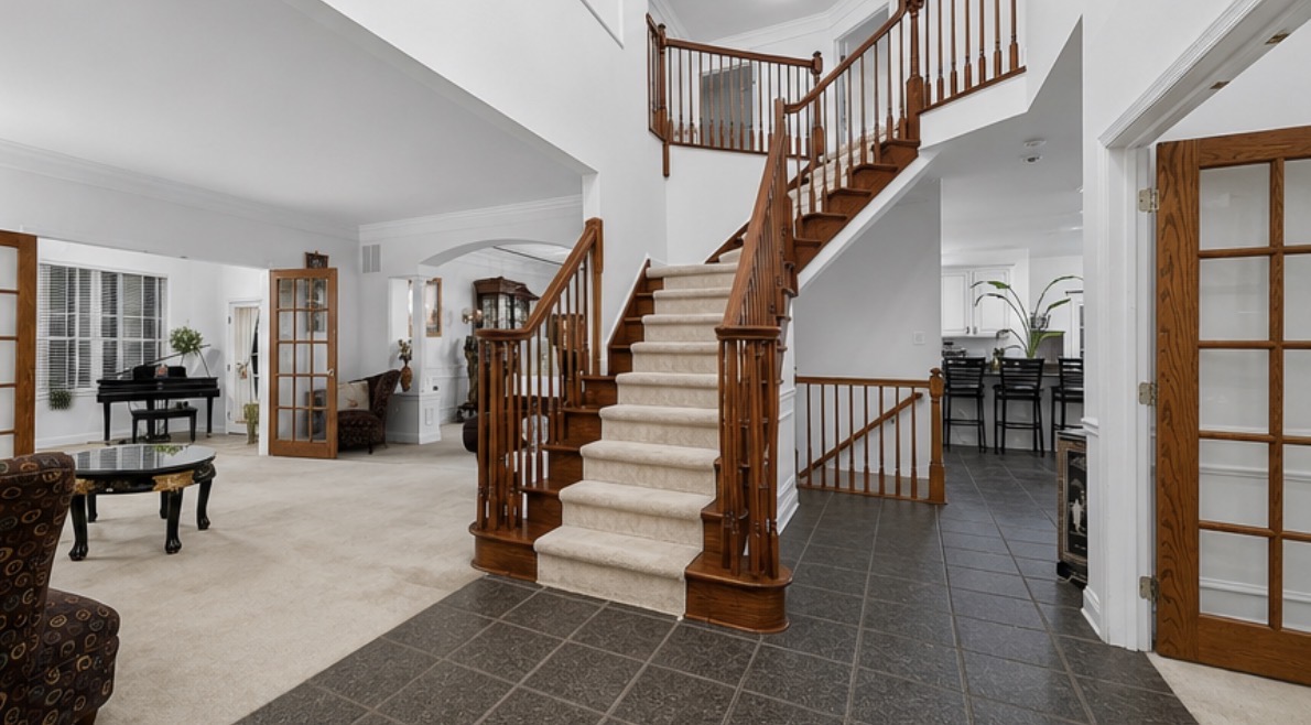 Freshly painted two-story foyer and staircase with white walls and trim in a South Jersey home